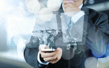 Double exposure of businessman shows modern technology as concept